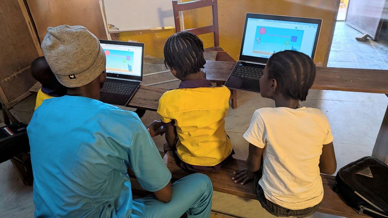 Students learning on laptops at the Digital Academy in Liberia