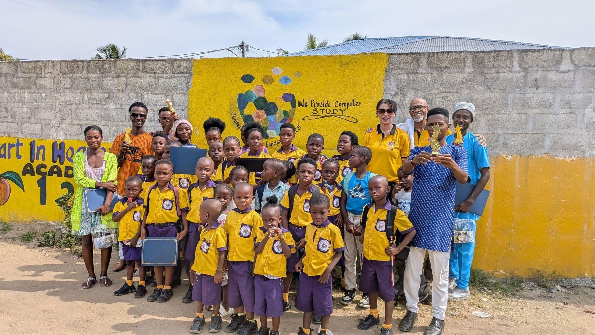 Champion Academy students gathered in front of the school wall in Liberia