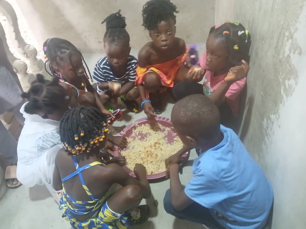 Children share a meal together through Christ Care Foundation's feeding program