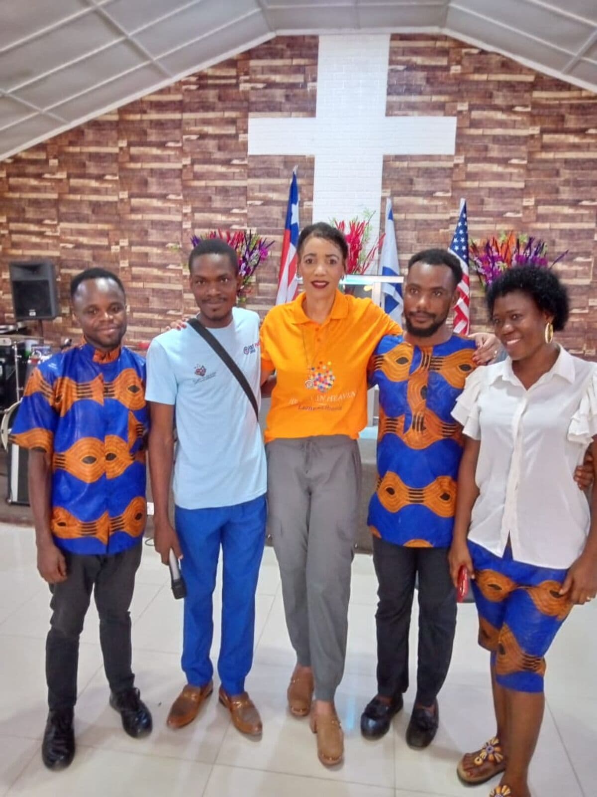 Ministry leaders gathered beneath a cross in a Liberian church